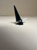 Silver fidget ring on black cone display stand, showing polished band with blue stripe detail