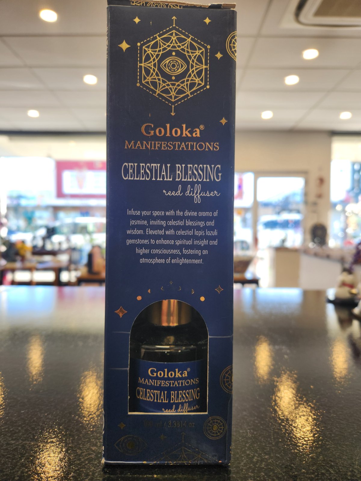 Goloka Manifestations Celestial Blessing reed diffuser in navy blue box with gold geometric design