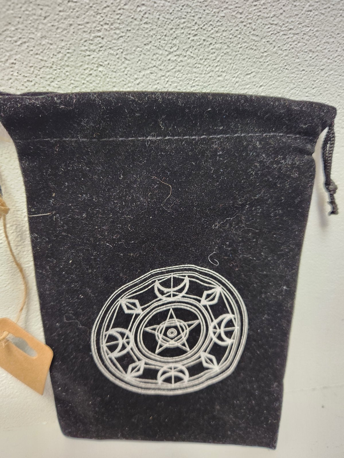 Black felt tarot card bag with silver embroidered pagan star circle design and drawstring closure