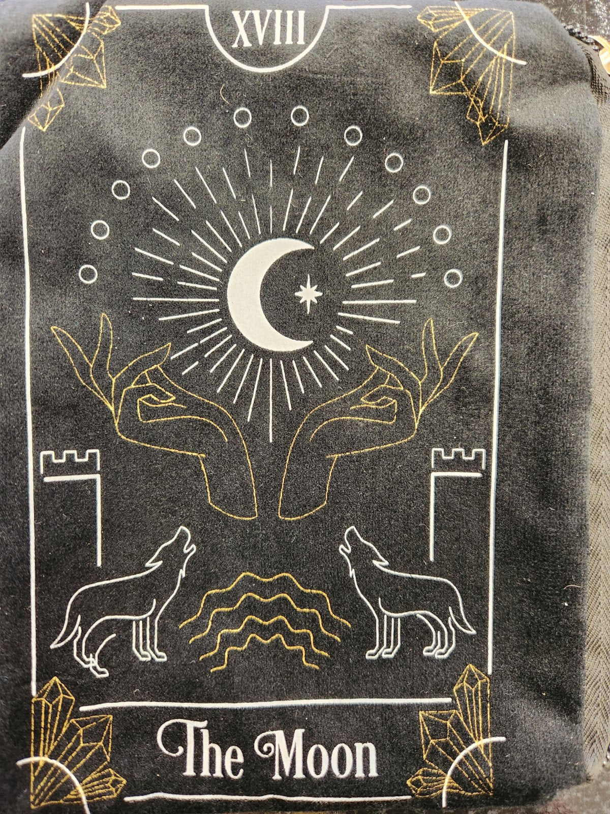 Black tarot card pouch featuring The Moon card design with white and gold line art