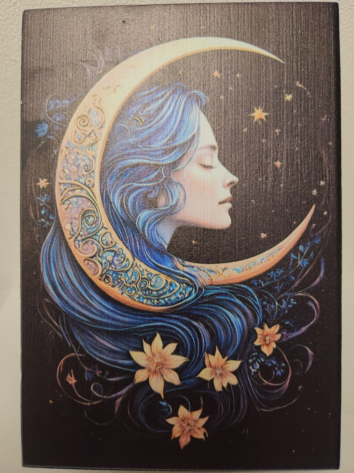 Decorative tarot box featuring profile of woman with blue hair and ornate crescent moon, adorned with flowers and stars