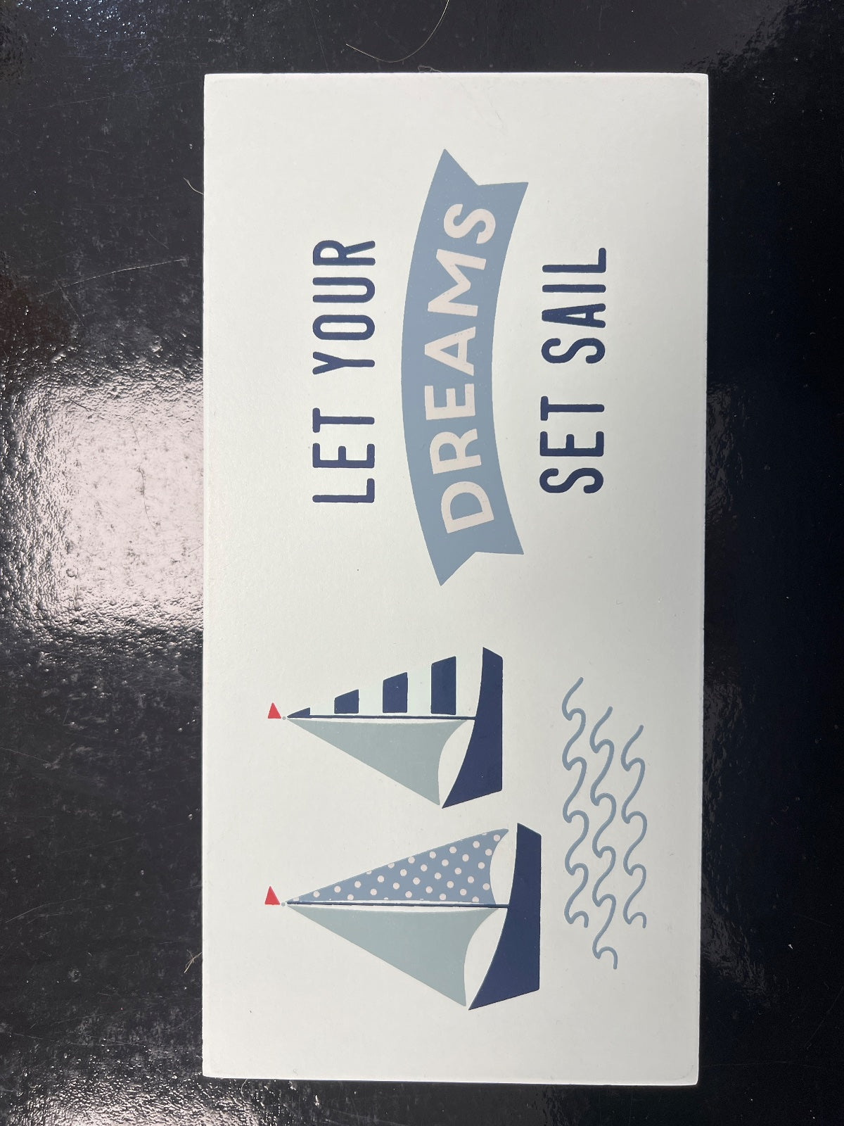 White MDF sign with nautical sailboat design, blue text reading 'Let your Dreams Set Sail', two illustrated boats with red flags
