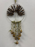 Tigers Eye crystal tree of life suncatcher with brown beaded branches in circular wire frame and dangling seed pods