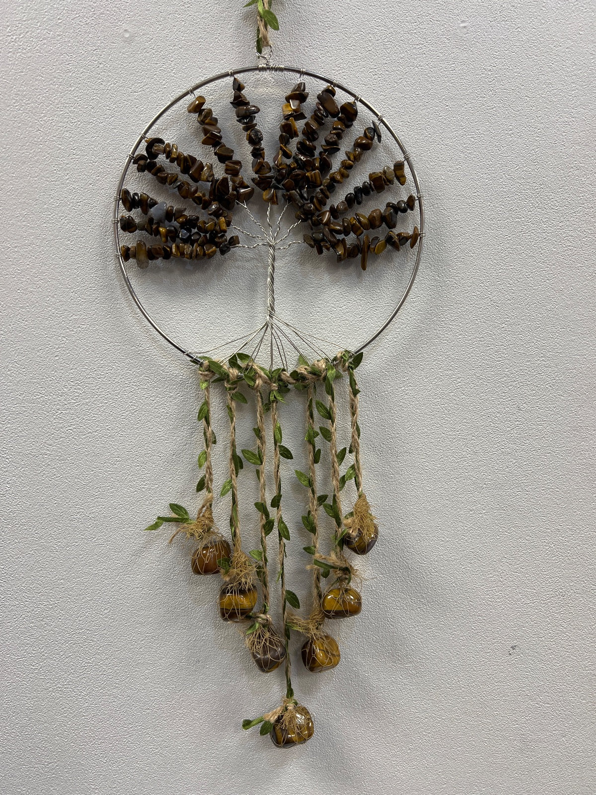 Tigers Eye crystal tree of life suncatcher with brown beaded branches in circular wire frame and dangling seed pods