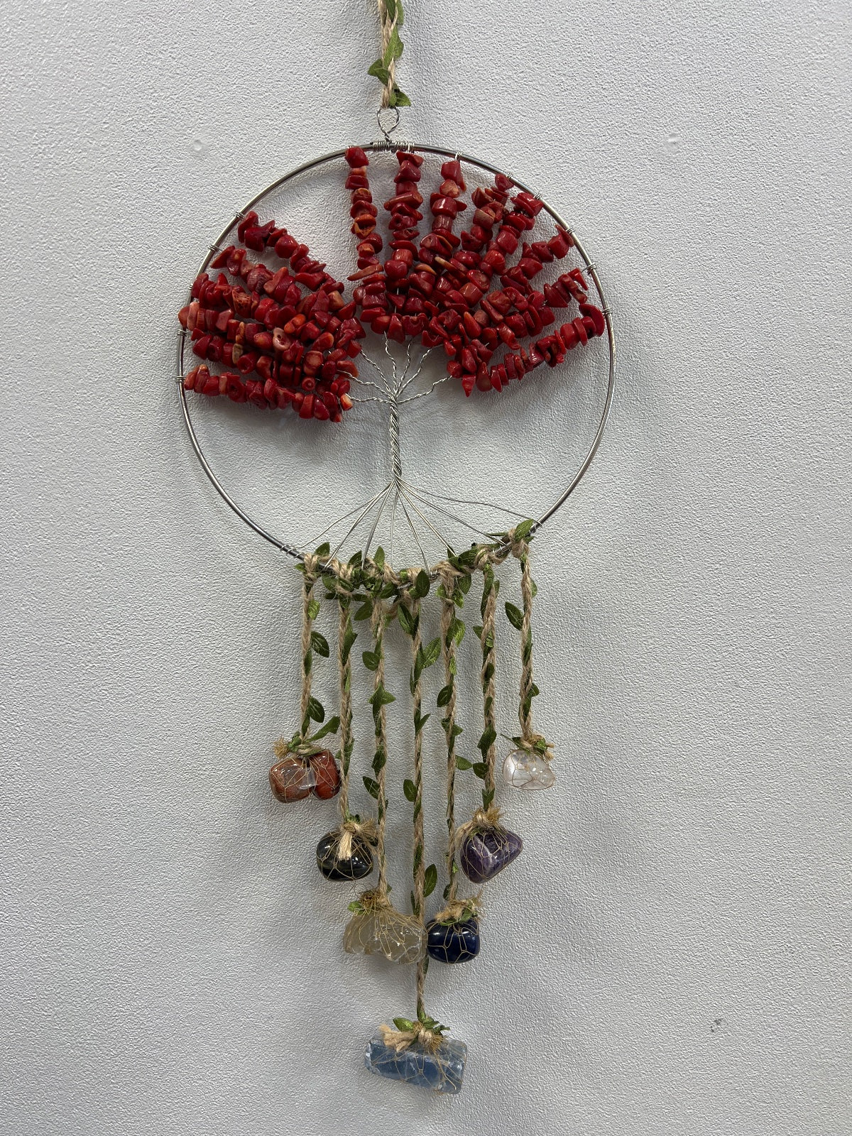 Red coral crystal tree of life suncatcher with wire frame, hanging stones, and green leaf accents