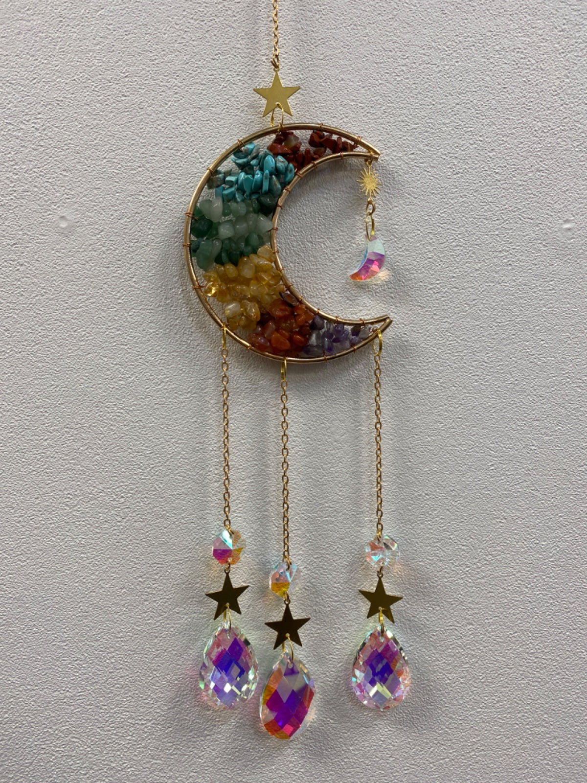 Gold crescent moon suncatcher filled with colorful chakra chips, with matching crystal pendants and stars hanging below