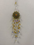 Yellow lotus metal suncatcher with dangling crystal beads in amber and clear tones