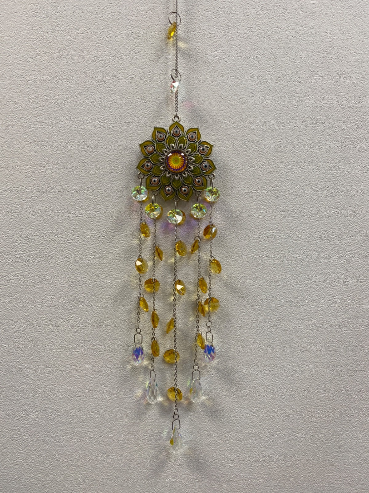 Yellow lotus metal suncatcher with dangling crystal beads in amber and clear tones