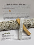 Palo Santo stick and sage bundle with wooden holder on educational cleansing guide sheet