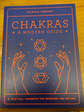 Chakras: A Modern Guide by Patricia Mercier, navy blue cover with orange line illustrations of hands and chakra symbols
