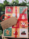 Christmas Crystal Starter Kit wrapped in festive paper with holiday illustrations, tied with red ribbon and kraft tag