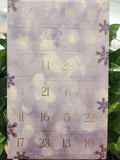 Crystal advent calendar with numbered doors 1-24, purple and white translucent design, decorative snowflake details