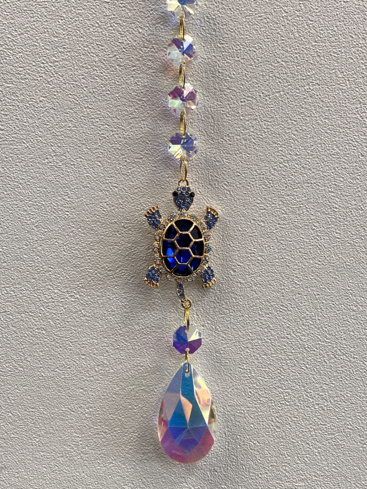Decorative turtle window hanger with purple faceted crystal beads and iridescent teardrop charm
