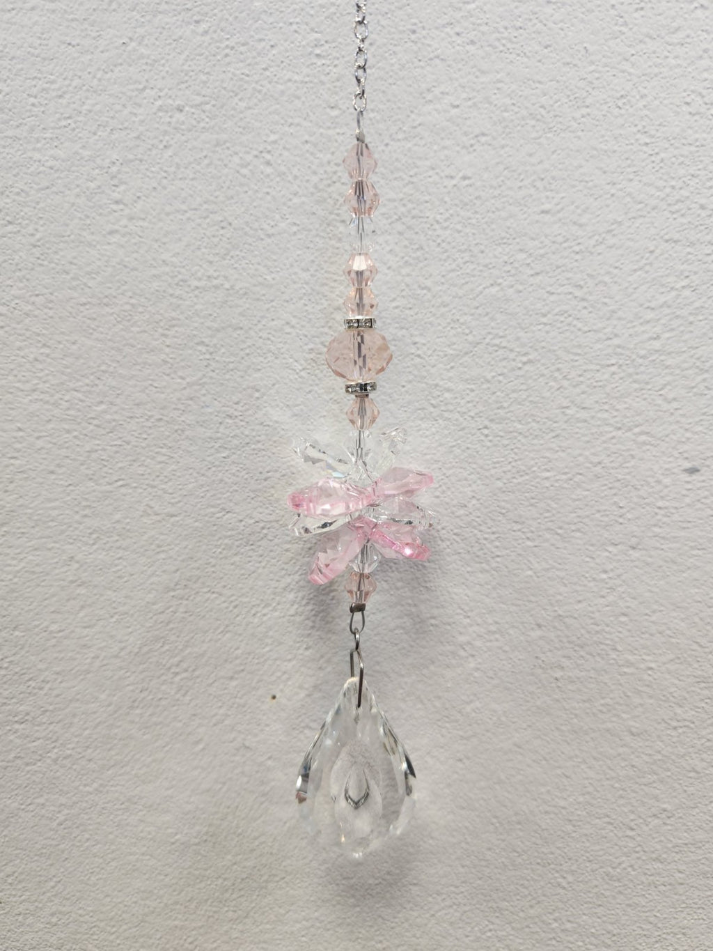 Pink beaded suncatcher with clear crystal charms and a teardrop pendant, hanging from a silver chain