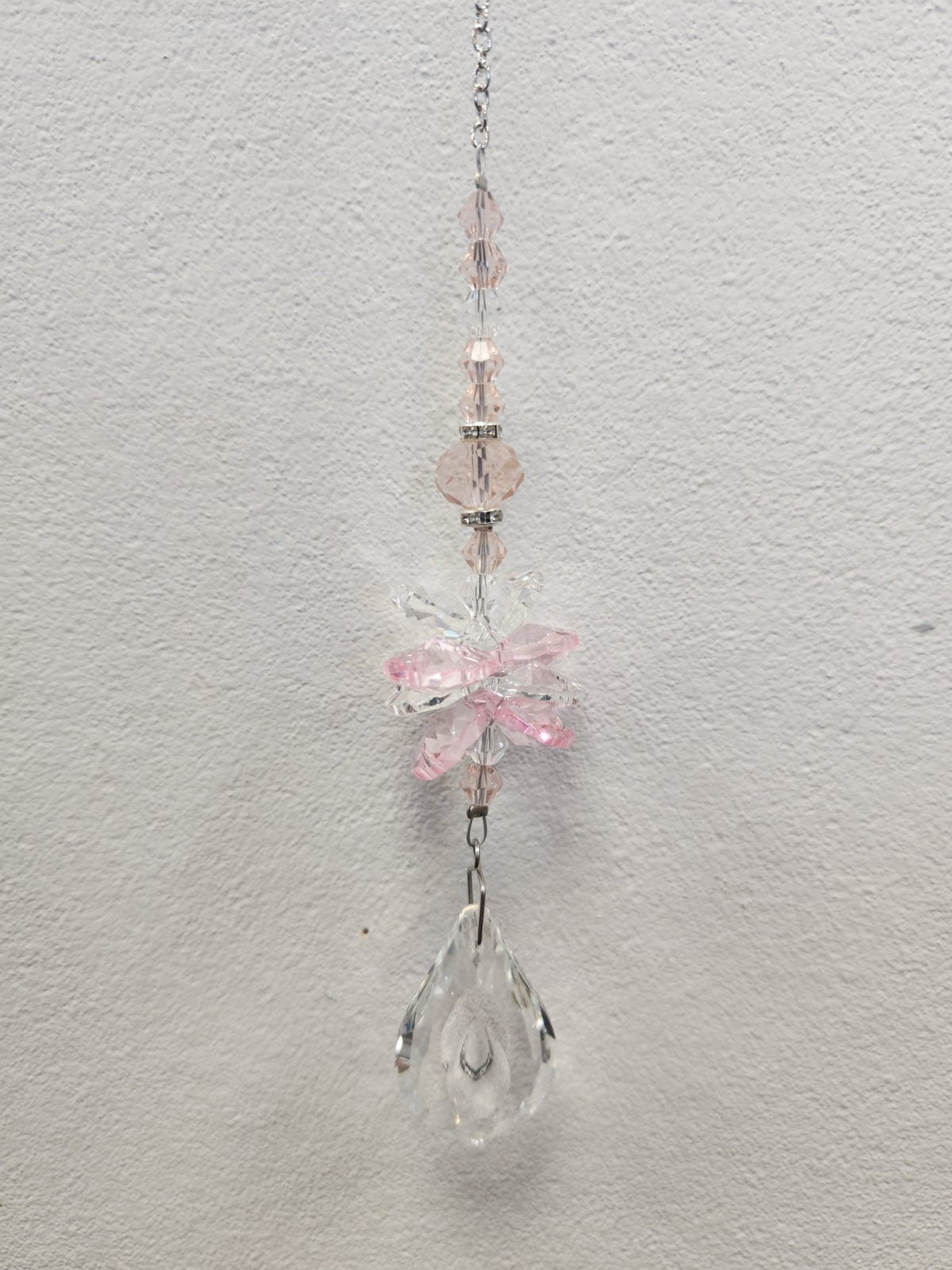 Pink beaded suncatcher with clear crystal charms and a teardrop pendant, hanging from a silver chain