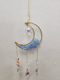 Gold crescent moon suncatcher with aquamarine stones, hanging crystal, and three beaded chains.