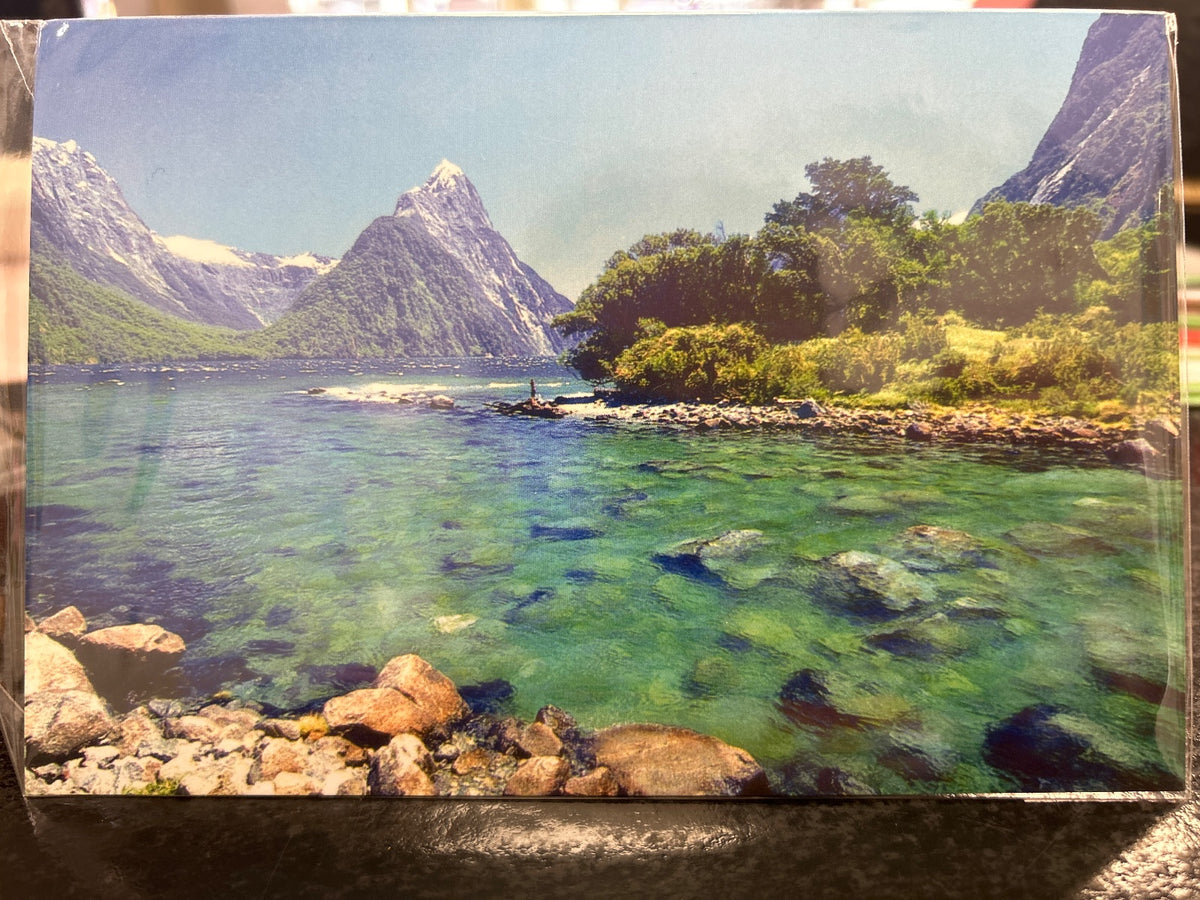 Milford Sound greeting card showing a fjord with emerald water, dramatic peaks, and native bush.