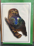 Greeting card featuring a brown morepork owl perched on a branch, with a nighttime forest scene visible within its body silhouette