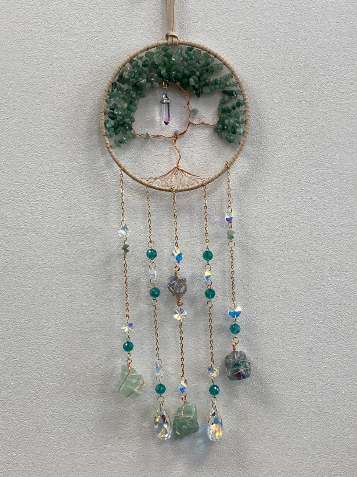 Circular Tree of Life wall hanging with green fluorite chips, copper wire frame, and five beaded chains with gemstone pendants