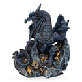 Dark blue-grey dragon figurine with spread wings guarding golden treasure and skull on rocky base