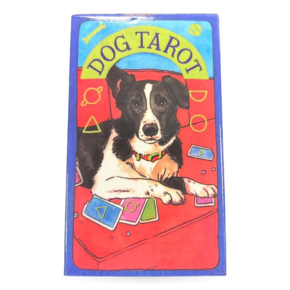 Dog Tarot Cards box featuring black and white dog with colorful tarot cards on red background