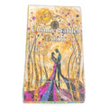 Cosmic Garden Tarot deck box featuring golden artwork with two figures and celestial botanical design