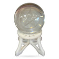 Clear quartz sphere with etched pentagram symbol in white decorative stand