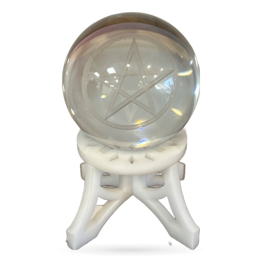 Clear quartz sphere with etched pentagram symbol in white decorative stand
