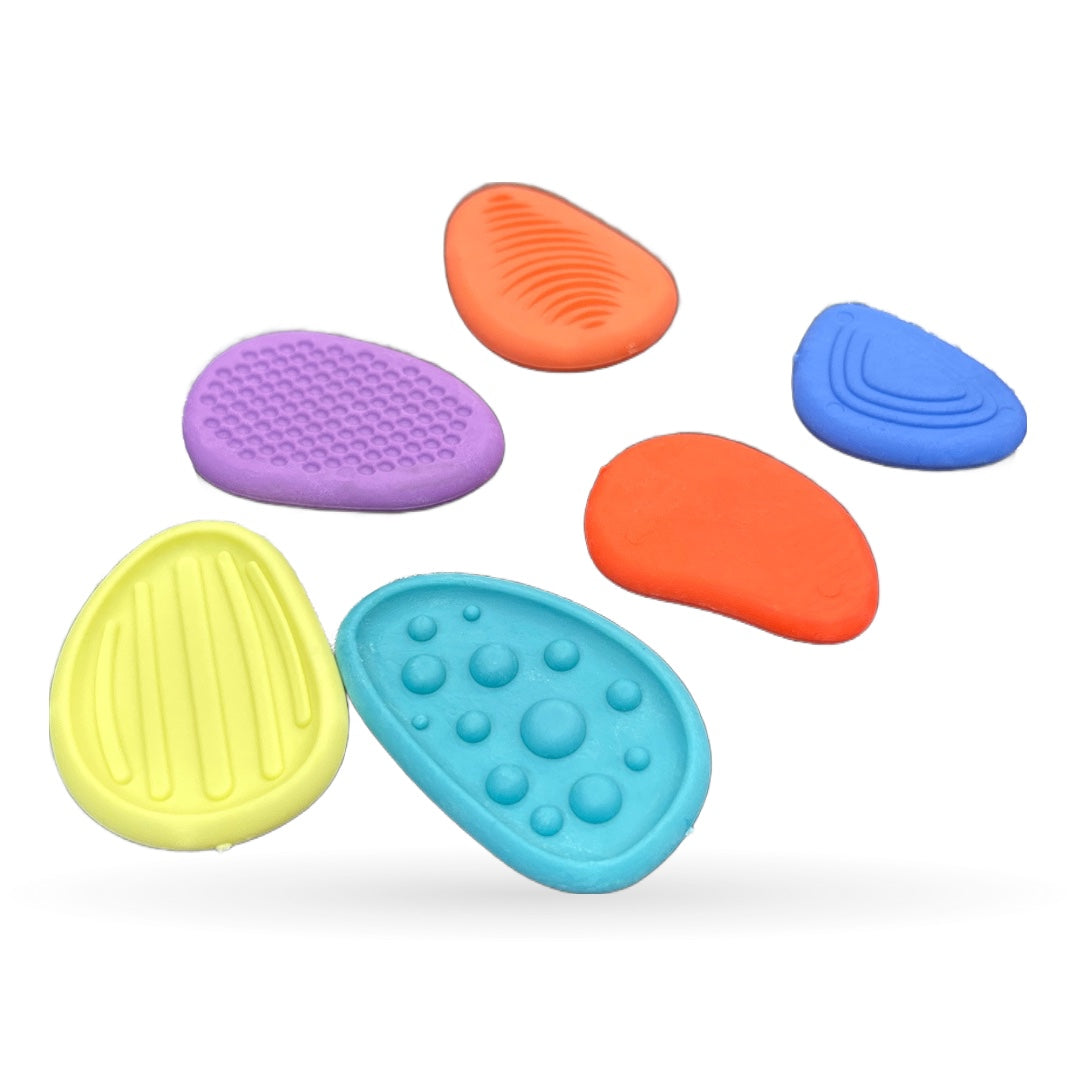 Six colorful oval sensory massage balls in yellow, purple, cyan, orange and blue with textured surfaces