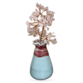 Rose quartz crystal money tree with pale pink stone leaves on copper wire branches in a two-tone ceramic pot