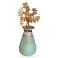 Citrine crystal money tree with golden tumbled stone branches in pale green ceramic vase with red accents