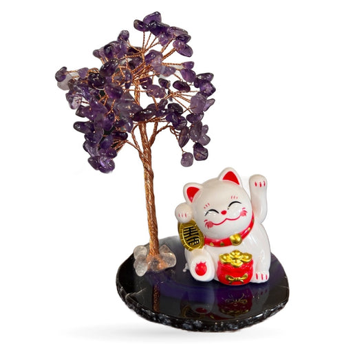 Amethyst money tree with gold wire on black agate base next to white lucky cat figurine
