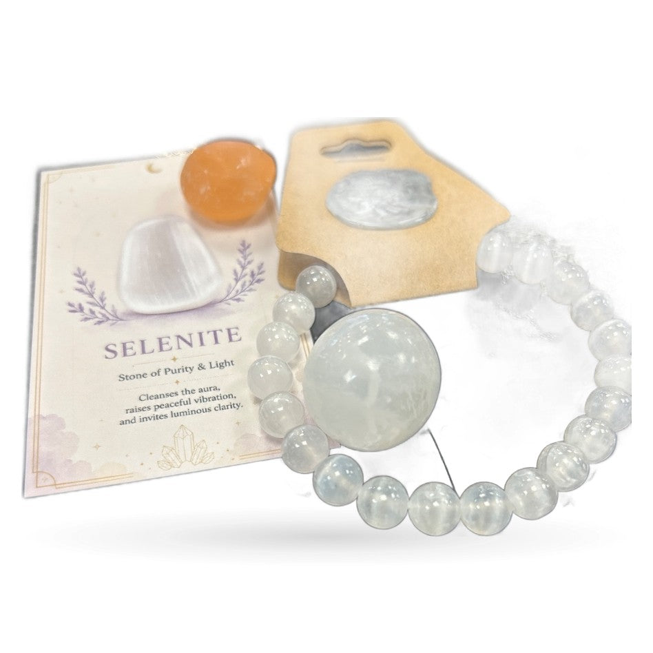 Selenite tumble stone, bead bracelet, and informational card with orange pouch on white background
