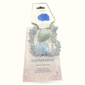 Aquamarine tumble stone with chip bracelet set on decorative product card with blue flower illustration