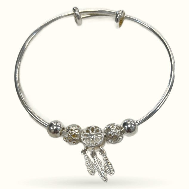 Silver dreamcatcher bracelet with filigree beads and dangling feather charms on bangle