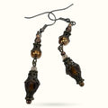 Pair of brown beaded earrings with ornate metal caps and smoky quartz drops on surgical steel hooks