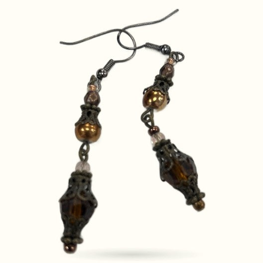 Pair of brown beaded earrings with ornate metal caps and smoky quartz drops on surgical steel hooks