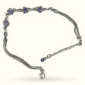 Silver bracelet with purple gem flower clusters and chain links with lobster clasp closure