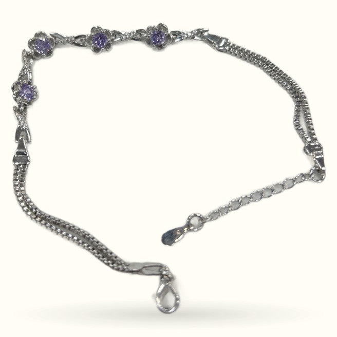 Silver bracelet with purple gem flower clusters and chain links with lobster clasp closure