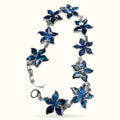 Paua flower shell bracelet with blue iridescent five-petal flower charms linked with silver-tone metal