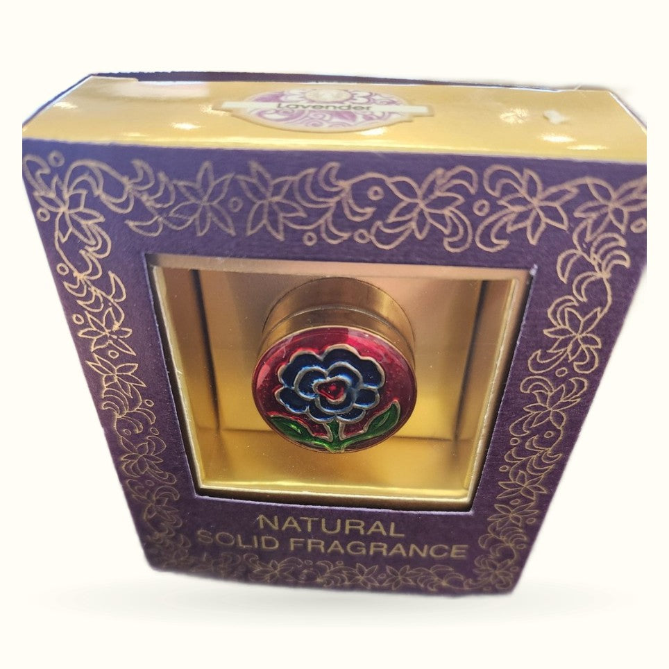 Purple decorative box containing a round solid fragrance tin with colorful flower design