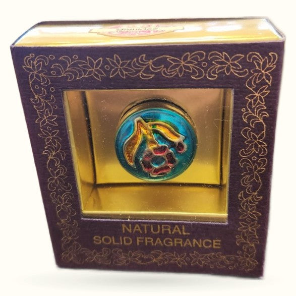 Orchidee Natural Solid Fragrance in decorative purple box with ornate gold patterns and circular blue/gold emblem