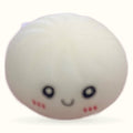 White round squishy dumpling toy with closed happy eyes, rosy cheeks, and a gentle smile