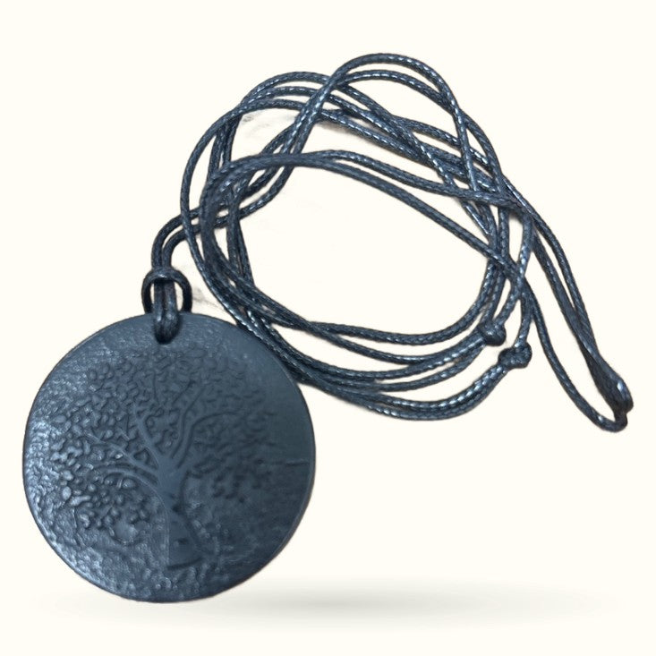 Shungite Tree of Life disc necklace with textured circular pendant on black braided cord
