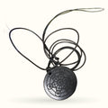 Black shungite disc pendant with sacred geometry pattern on black cord necklace
