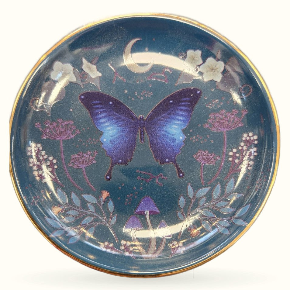 Deep teal trinket dish with purple butterfly, moon, flowers, mushrooms, and gold rim