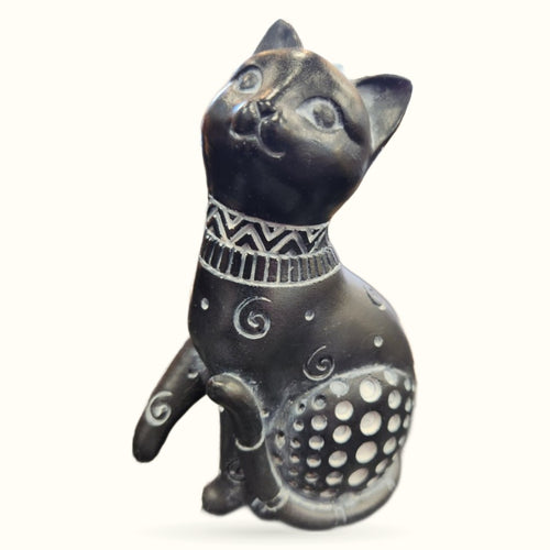 Black ceramic cat ornament sitting upright with decorative collar and patterned belly, 12cm tall