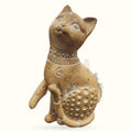 Tan ceramic cat ornament sitting upright, decorated with collar and patterned belly, gazing upward
