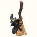 Black cat figurine wearing witch hat and holding wooden broomstick with pentagram charm