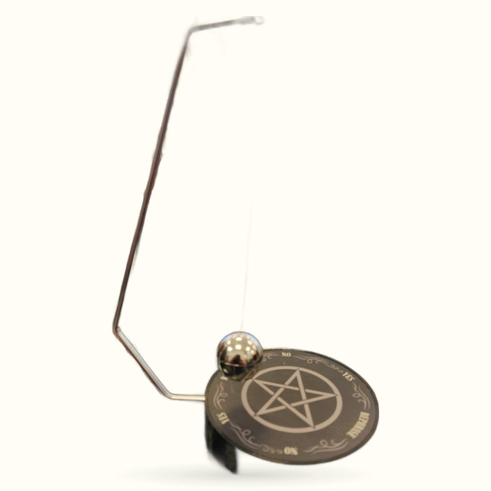 Brass pendulum with decorative disc featuring pentagram symbol and ornamental border design